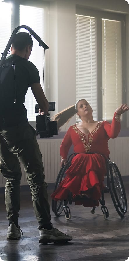 Woman in wheelchair and filmmaker recording her