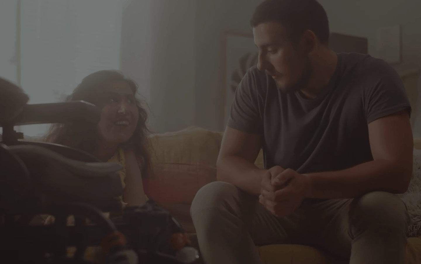 Man speaking and woman smiling